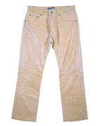 A pair of beige calfskin leather pants with a front zipper and button closure, displayed against a white background. Vintage Vent Couvert beige calfskin leather pants/trousers with a smooth glossy finish; mid-rise straight leg, five-pocket jeans styling with belt loops, button front and subtle knee seams. High-end, luxury, rare piece laid flat on white.
