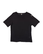 Black t-shirt on a white background. Gianfranco Ferré black short-sleeve T-shirt; crafted from soft cotton with a subtle shoulder logo patch and relaxed fit; features clean lines and Italian minimalist tailoring; understated design reflecting Ferré’s refined architectural approach to fashion and timeless sophistication.