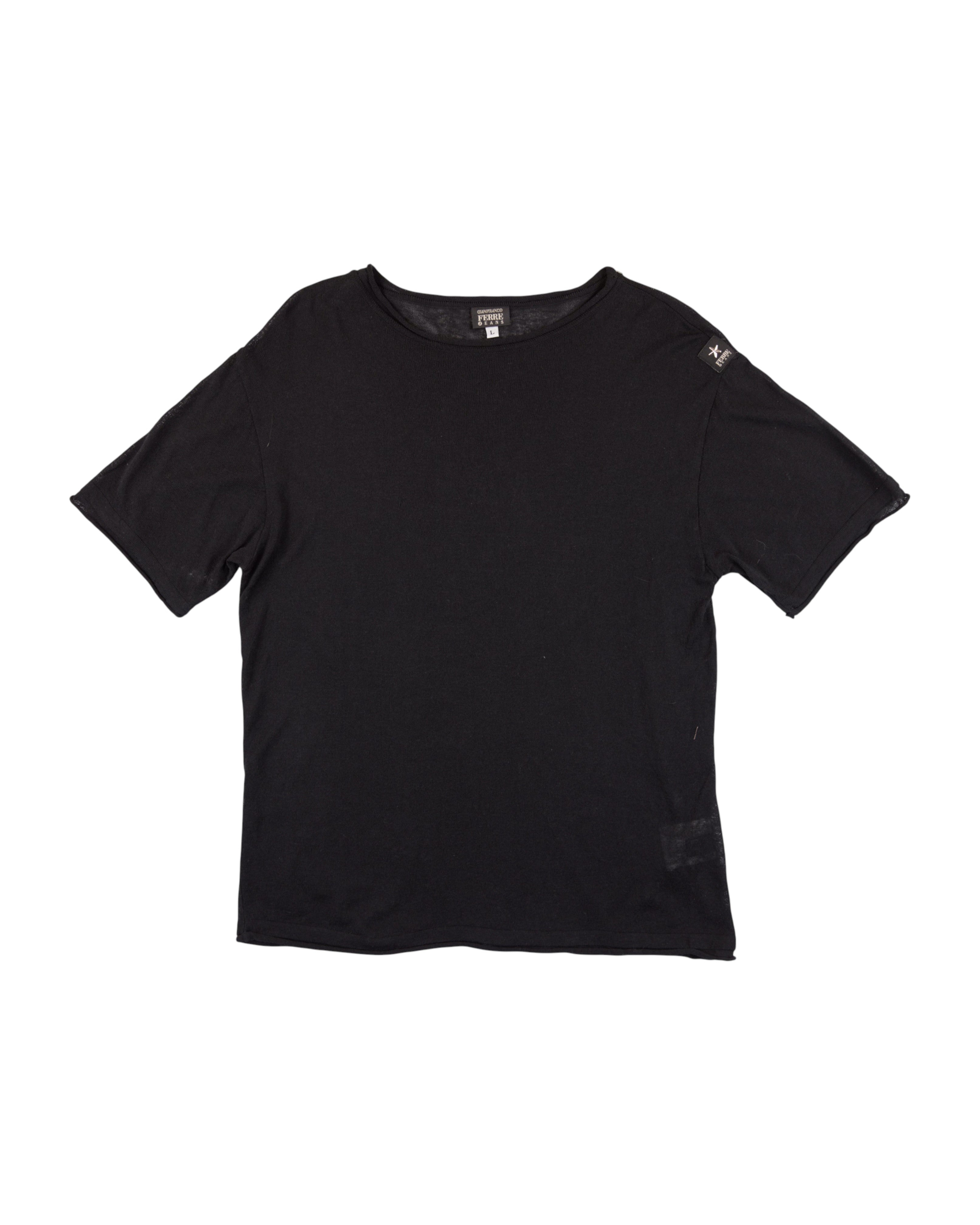 Black t-shirt on a white background. Gianfranco Ferré black short-sleeve T-shirt; crafted from soft cotton with a subtle shoulder logo patch and relaxed fit; features clean lines and Italian minimalist tailoring; understated design reflecting Ferré’s refined architectural approach to fashion and timeless sophistication.