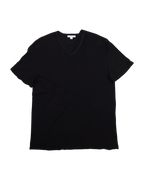 Black t-shirt on a white background. James Perse deep black V-neck short-sleeve T-shirt; soft premium cotton jersey with minimalist neckline and relaxed drape; lightweight breathable texture emphasizing understated California luxury; versatile wardrobe essential blending casual comfort and timeless refinement with signature laid-back elegance.