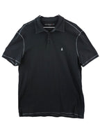 Black polo shirt with white accents on a white background. John Varvatos black/dark charcoal cotton-jersey polo shirt; contrast topstitching, soft washed hand, 2-button placket, classic knit collar; chest peace-hand embroidery; regular–slim fit, unisex; easy with jeans, chinos, under leather; style tags: rock, minimal, Americana, smart casual; American luxury label from NYC.