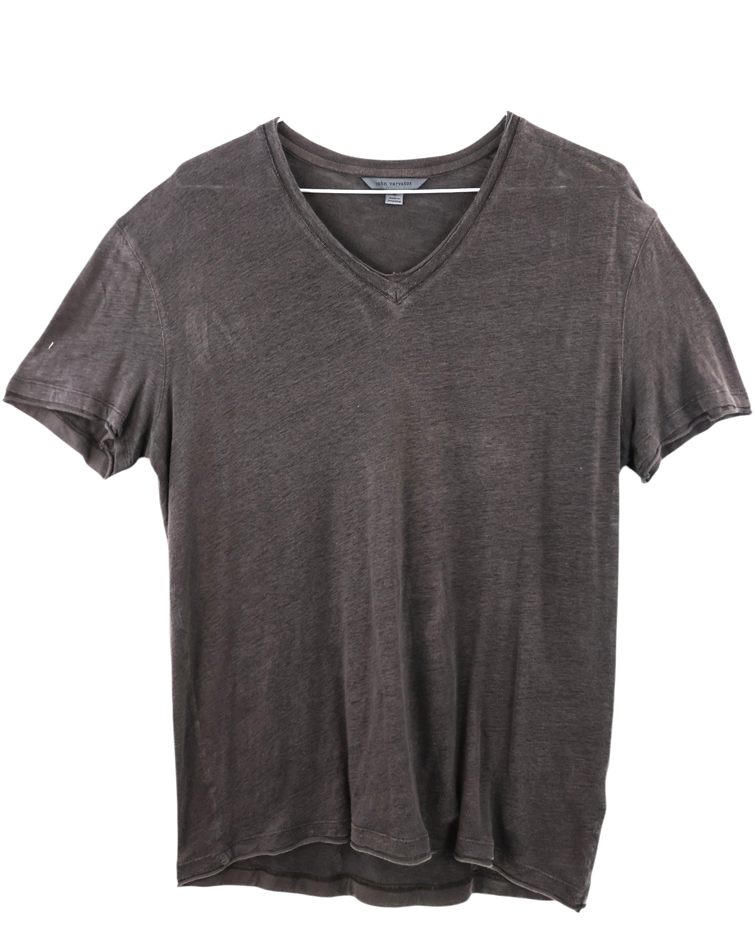 Gray t-shirt on a white background. John Varvatos washed charcoal V-neck T-shirt; soft slub jersey with a vintage fade, short sleeves, raw-edge neckline and sleeves, relaxed fit—easy rock-inspired basic. Essential John Varvatos V-neck tee in washed charcoal. Crafted from ultra-soft slub cotton with a lived-in fade and subtle raw edges for that signature JV rock vibe. Effortless with jeans or under a leather jacket. Shop now!