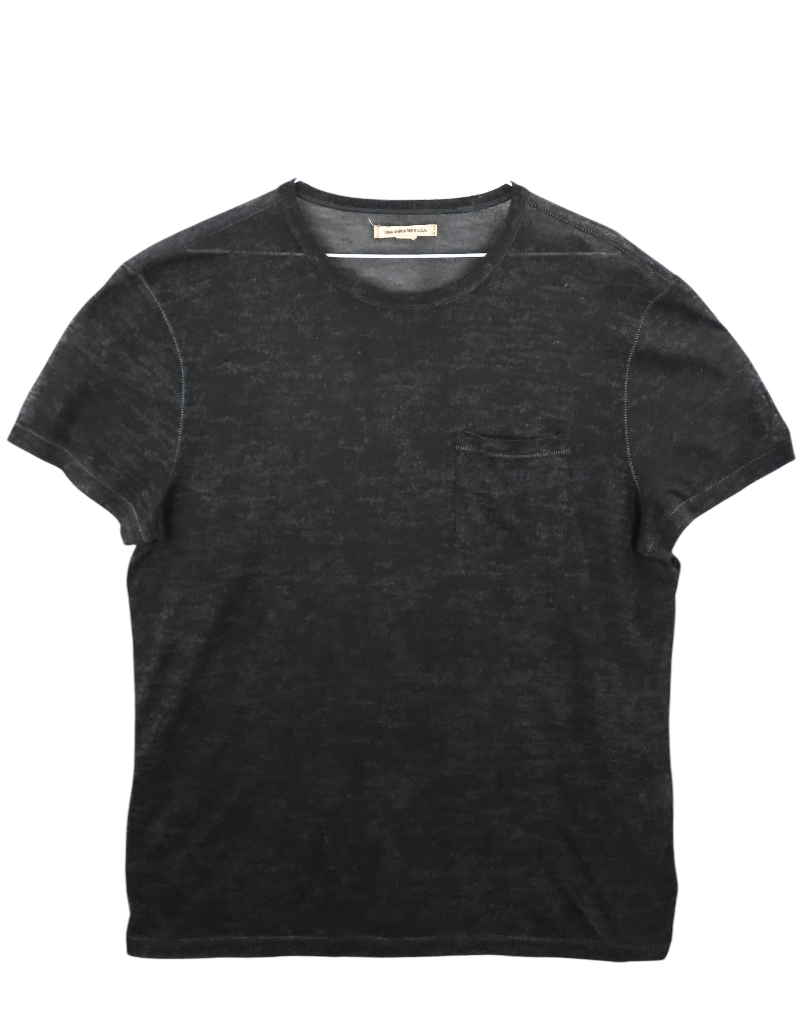 Black t-shirt on a white background. John Varvatos faded black burnout crewneck T-shirt; lightweight semi-sheer cotton blend with mottled texture and tonal chest pocket; soft worn-in finish with minimalist stitching; relaxed vintage silhouette embodying casual luxury and refined American rock-inspired craftsmanship.