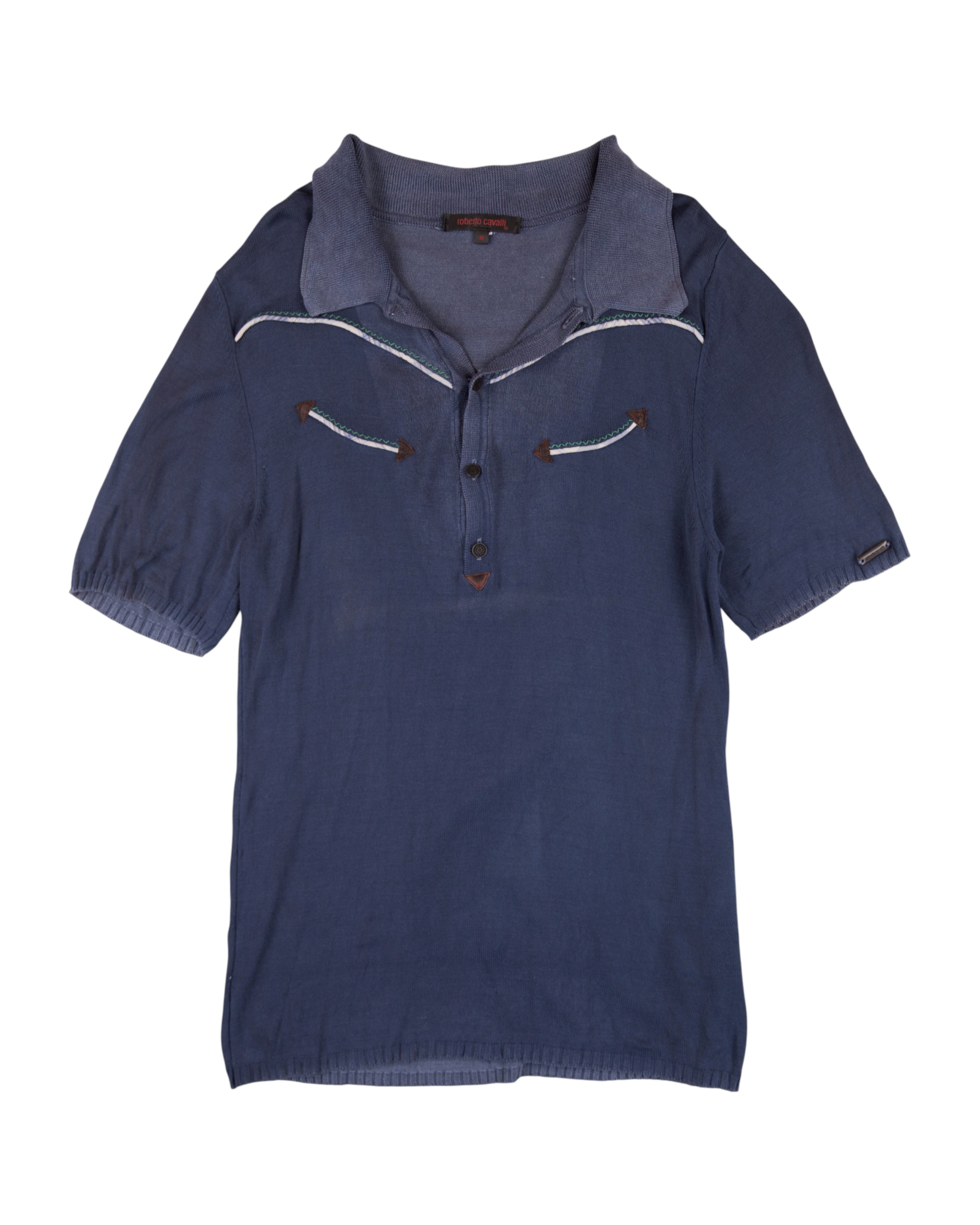 Blue polo shirt with white trim on a white background. Roberto Cavalli navy/ink-blue linen-cotton polo shirt; open half-placket and soft spread knit collar; contrast western piping with arrow appliqués at chest; short sleeves with elastic hems; lightweight summer knit; slim/regular fit, unisex casual; Y2K/western vibe; Italian luxury house craftsmanship, rare vintage.