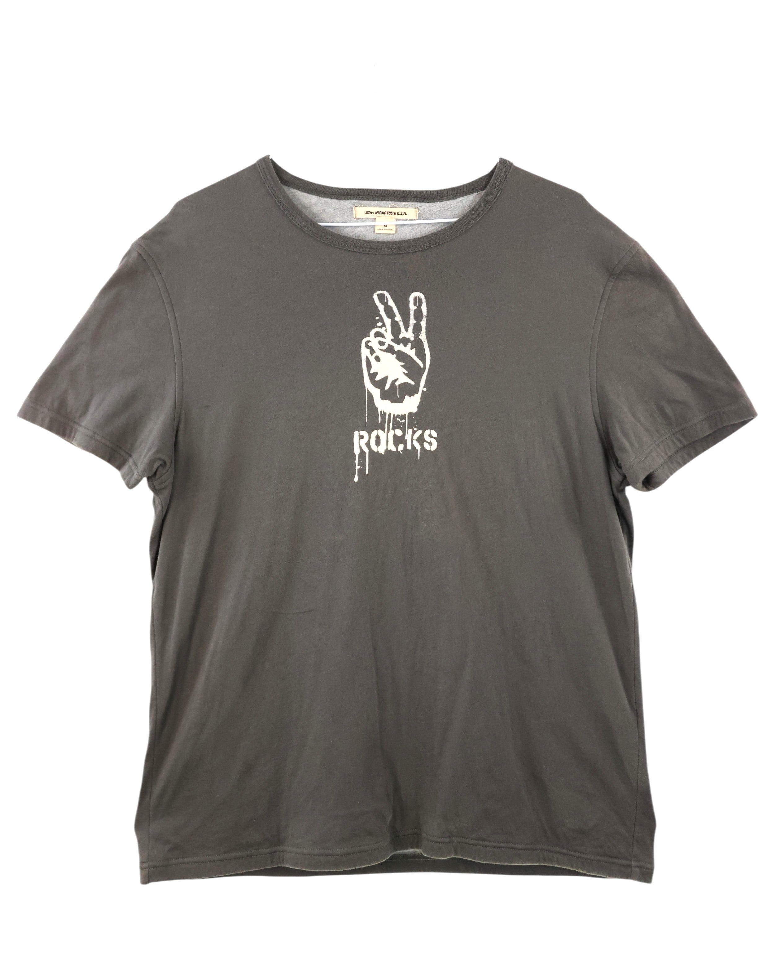 Gray t-shirt with a white graphic design on a white background. John Varvatos charcoal grey graphic T-shirt featuring a white distressed peace-hand “Rocks” print; soft washed cotton jersey with crewneck and short sleeves; relaxed vintage fit blending rebellious rock attitude and refined American luxury craftsmanship; effortlessly casual and collectible second-hand staple.