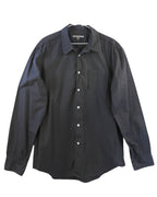 John Varvatos black cotton poplin button-up shirt; classic collar, white buttons, single chest pocket, curved hem; regular-slim fit, unisex; wears with denim, tailoring, leather jackets; style tags: rock, minimal, smart casual; brand context: American luxury label from NYC known for artisanal rock-tailoring; 2000s vibe, versatile wardrobe staple.