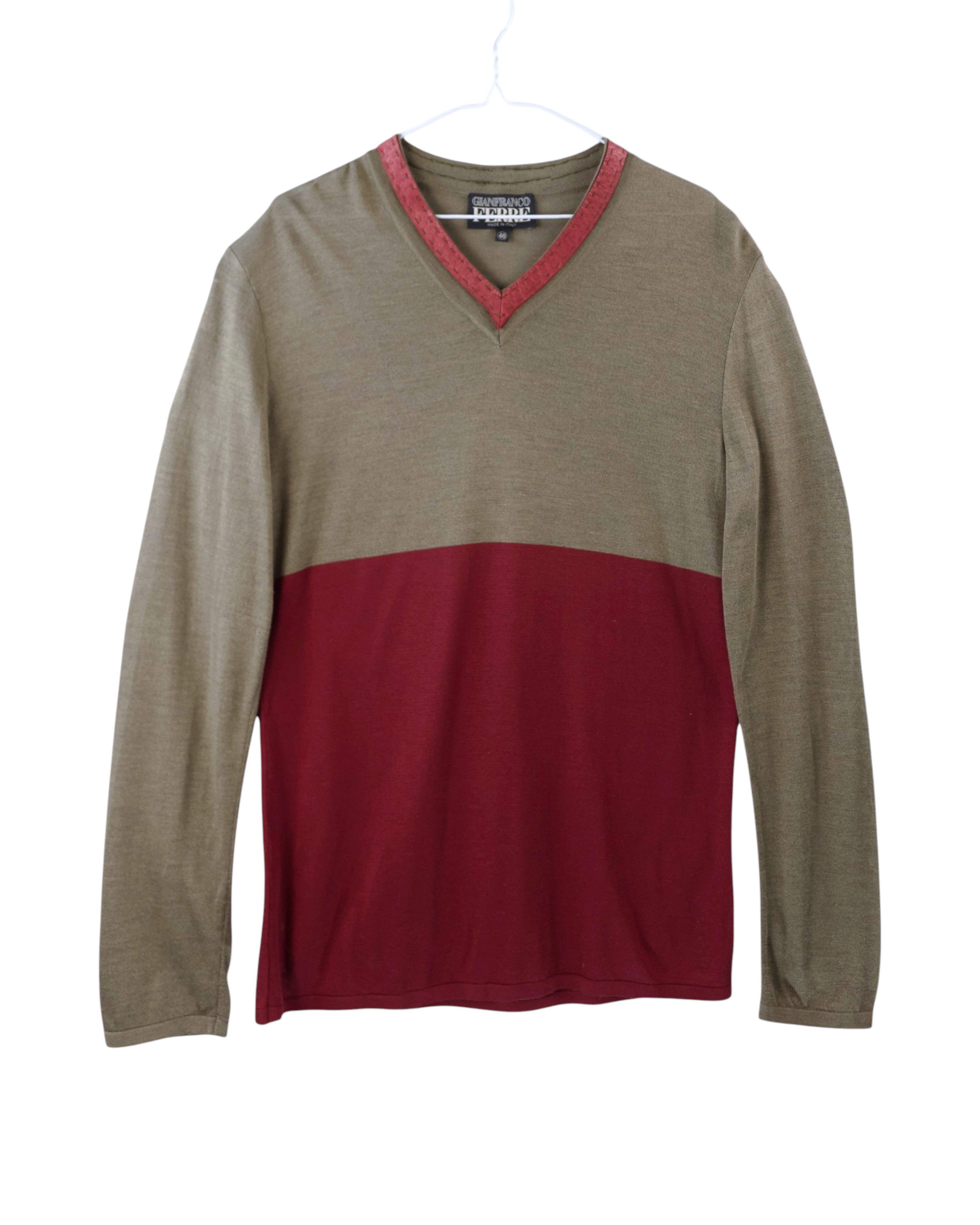 Two-tone long-sleeve shirt with red and brown colors on a white background. Gianfranco Ferré two-tone long-sleeve shirt featuring a deep V-neckline with red trim; upper taupe section contrasts with rich burgundy lower half; crafted from soft cotton blend, showcasing refined Italian craftsmanship and Ferré’s signature balance of structure and casual luxury.