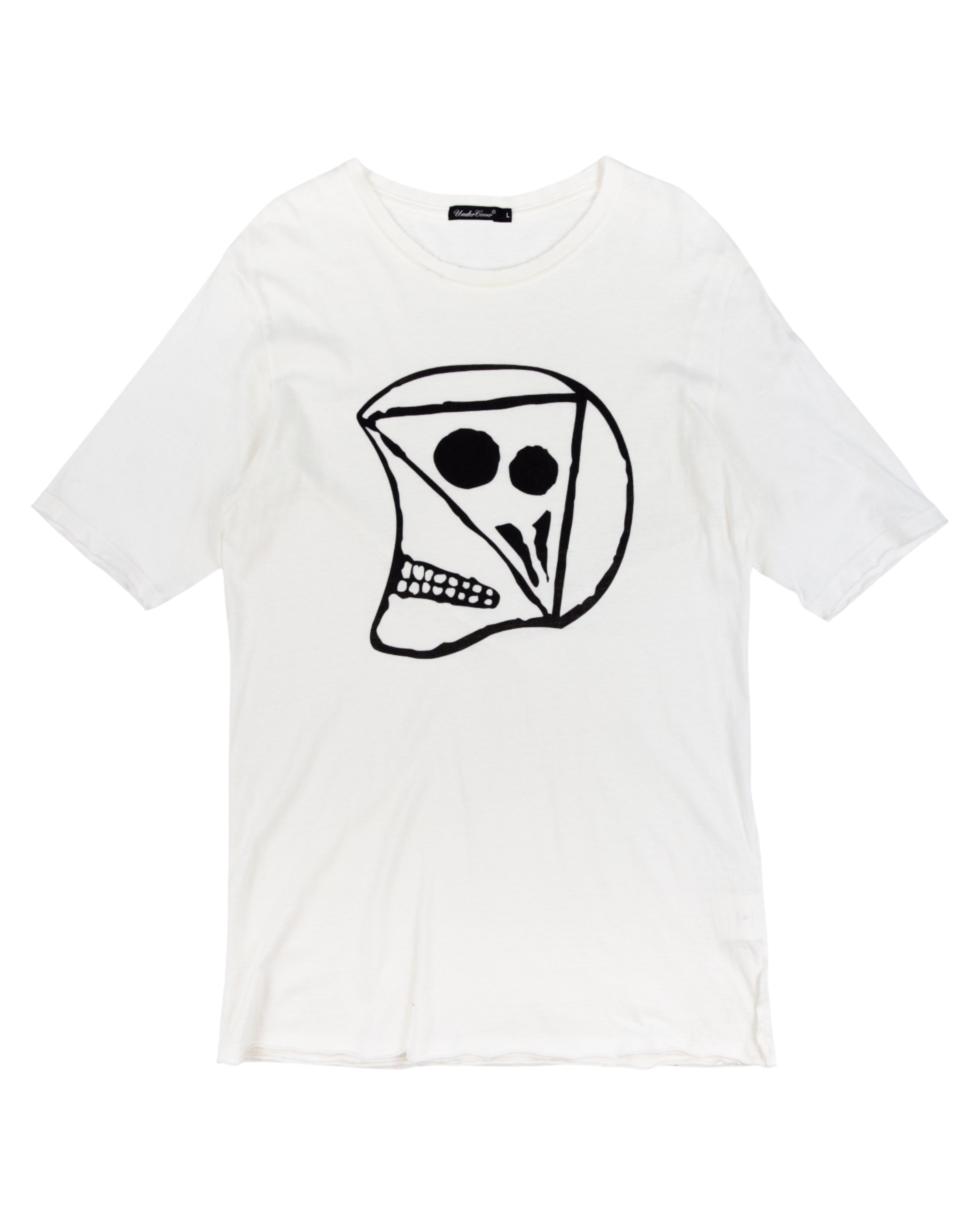 White t-shirt with a black graphic design on a white background. Undercover white/ivory cotton jersey T-shirt; bold black abstract skull/face graphic print, crewneck, short sleeves, slight distressing at hem; relaxed unisex fit; easy with denim, cargos or layered tailoring; style tags: punk, grunge, streetwear, graphic, avant-garde; brand context: Japanese cult label by Jun Takahashi, artisanal/luxury design.