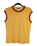 Yellow sleeveless shirt with red trim on a hanger against a white background. Vintage D&G Dolce & Gabbana mustard/yellow sleeveless T-shirt / tank / muscle tee / vest in soft cotton jersey; contrast burgundy/brick-red rib crewneck and armholes; minimalist solid color, fitted casual athleisure top; Italian designer brand from Milan (Italy), early-2000s/Y2K vibe; unisex layering shirt for streetwear or summer looks.