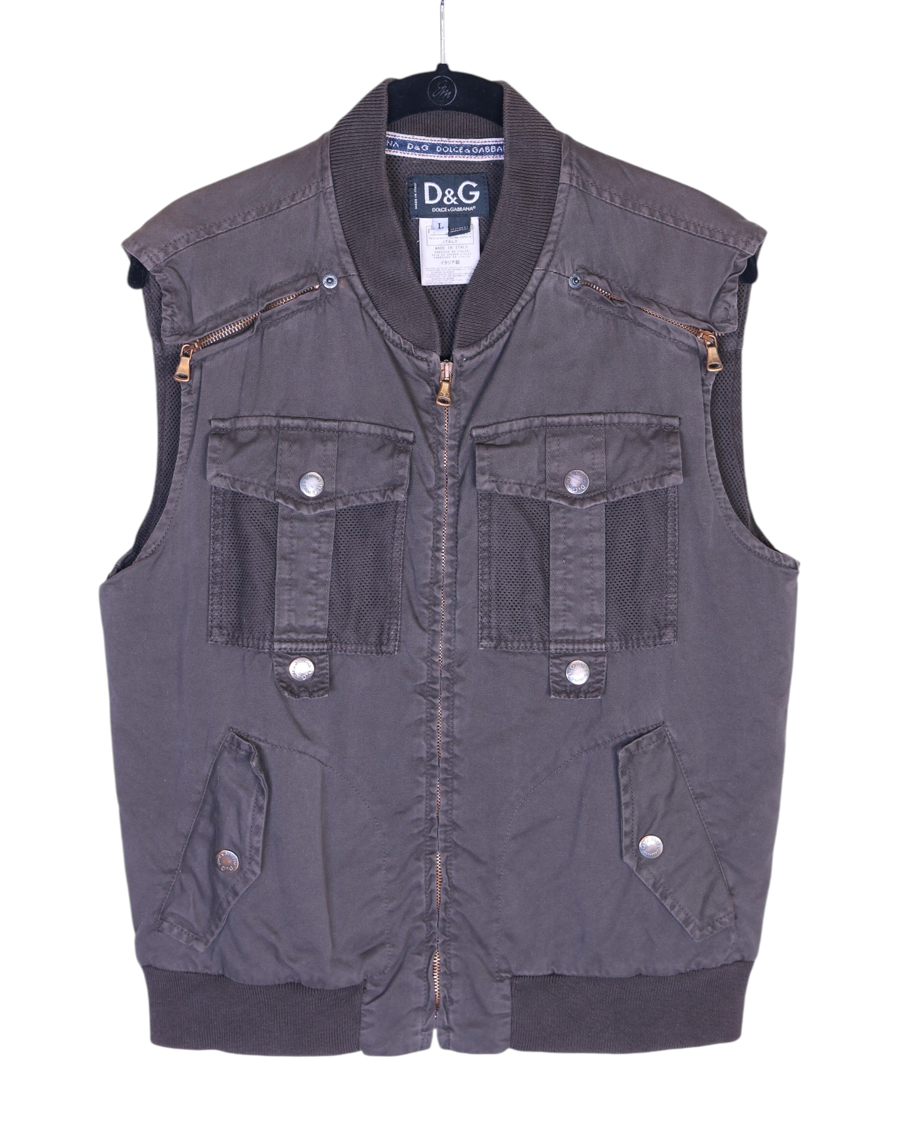 Dolce & Gabbana (D&G) 2003 utility vest / gilet / sleeveless jacket in charcoal grey—zip-front, ribbed bomber collar and hem, snap-flap cargo pockets, mesh pocket panels, chest zip pockets, technical nylon-cotton twill, sport/techwear and workwear vibe, Y2K street style layering piece. Italian luxury label known for Milan fashion heritage and sharp tailoring; unisex layer over tees, hoodies or shirts.